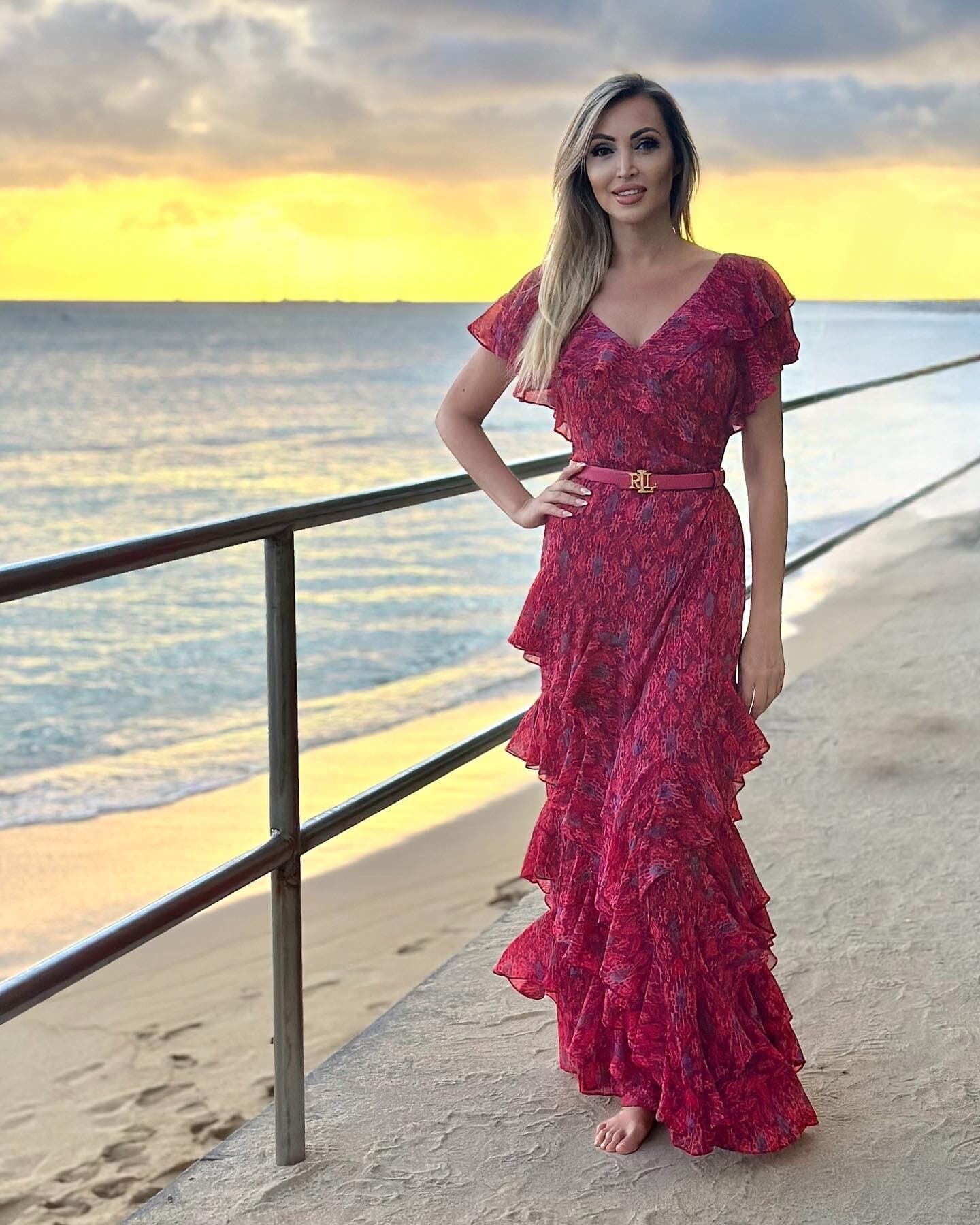 Veronika Mindal in a red ruffled dress at sunset